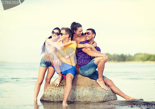 Image of group of friends having fun on the beach