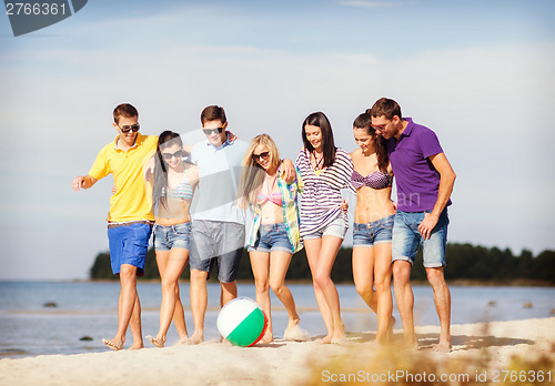 Image of group of friends having fun on the beach