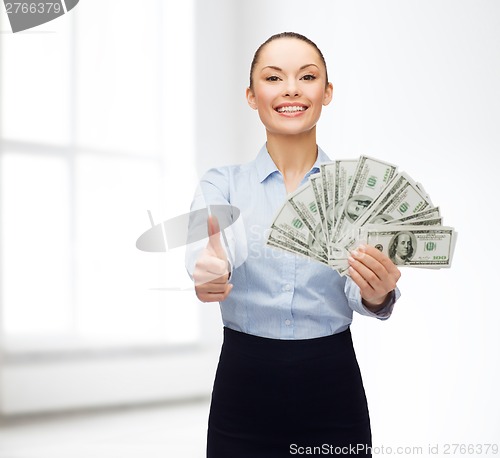 Image of young businesswoman with dollar cash money