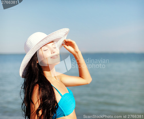 Image of girl in bikini standing on the beach