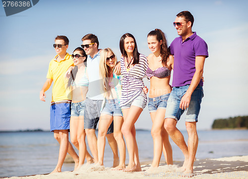 Image of group of friends having fun on the beach