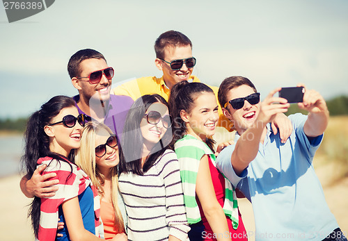 Image of group of friends taking picture with smartphone