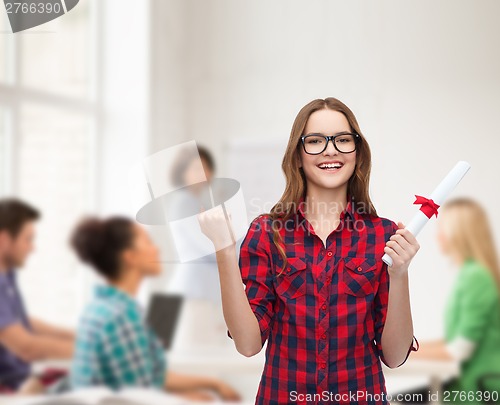 Image of smiling female student in eyeglasses with diploma