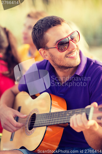 Image of group of friends having fun on the beach