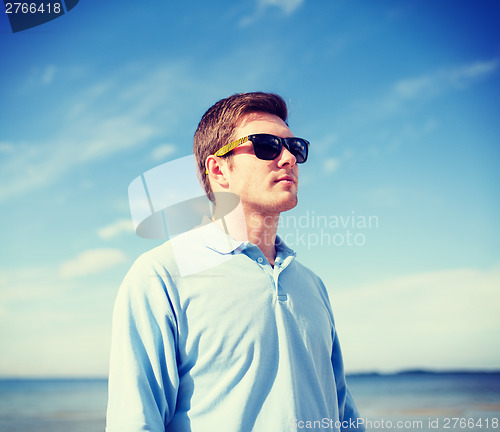 Image of man in sunglasses on the beach