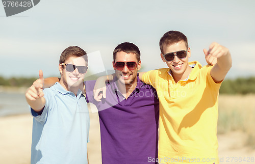 Image of group of friends having fun on the beach