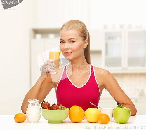 Image of smiling young woman eating healthy breakfast