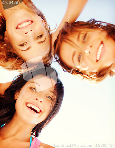 Image of girls faces with shades looking down