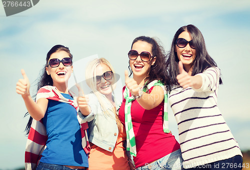 Image of teenage girls or young women showing thumbs up
