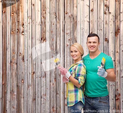 Image of smiling couple with paintbrush