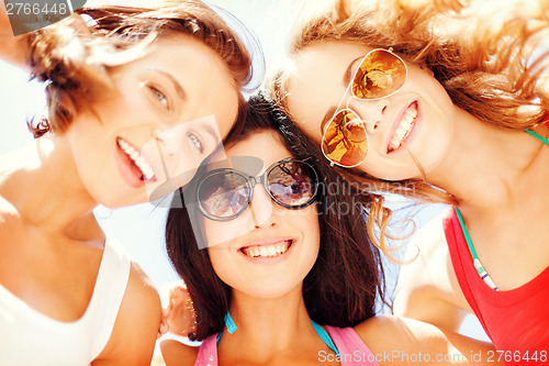 Image of girls faces with shades looking down