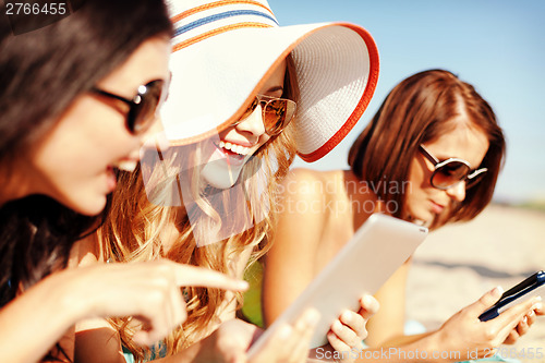 Image of girls with tablet pc on the beach