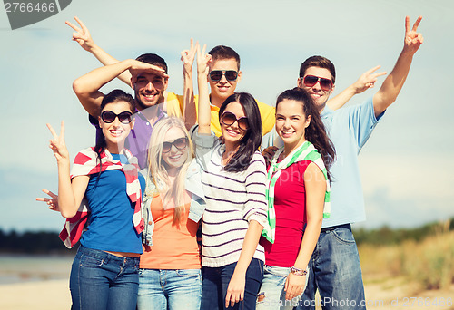 Image of group of friends having fun on the beach