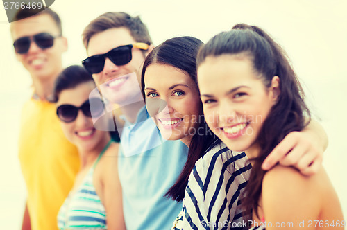 Image of group of friends having fun on the beach