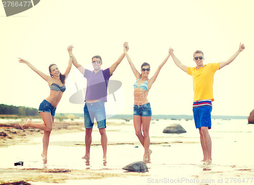 Image of group of friends having fun on the beach