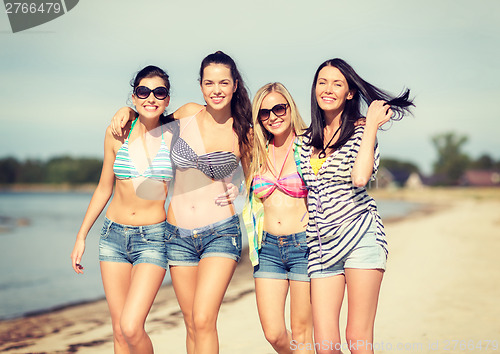 Image of girls in bikinis walking on the beach