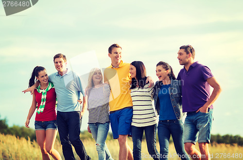 Image of group of friends having fun on the beach
