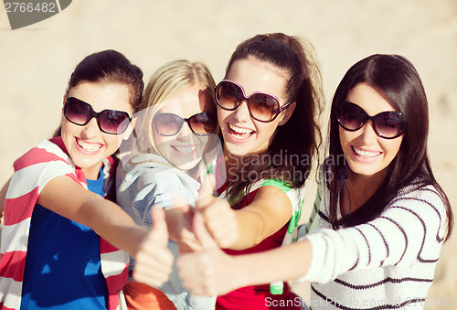 Image of teenage girls or young women showing thumbs up