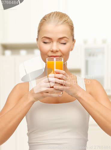 Image of young woman drinking orange juice