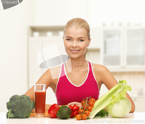 Image of smiling young woman with organic food on the table