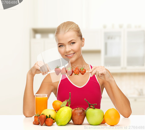 Image of smiling young woman with organic food on the table