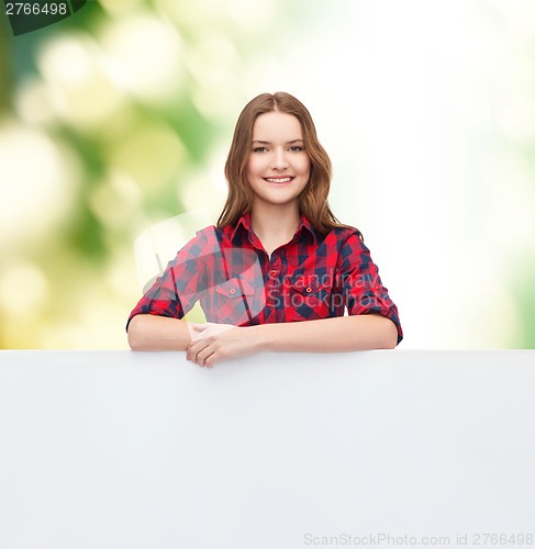 Image of smiling young teenage girl with white blank board