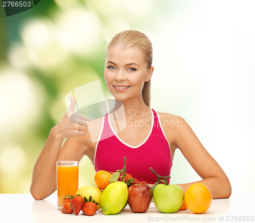 Image of smiling woman with organic food or fruits on table
