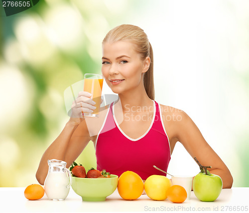 Image of smiling young woman eating healthy breakfast