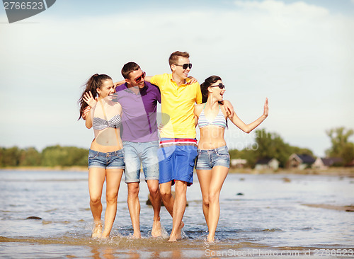Image of group of friends having fun on the beach