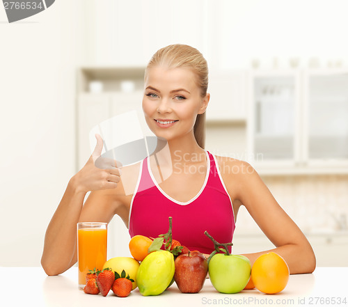 Image of smiling woman with organic food or fruits on table