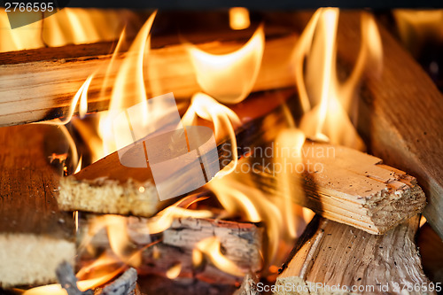 Image of firewood burning in fireplace