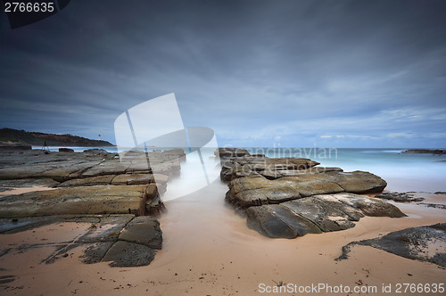 Image of Stormy beach with natural rock channel Soldiers Beach point