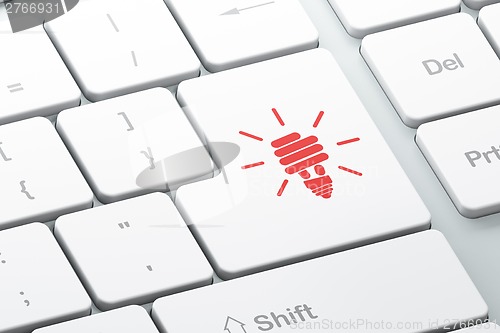 Image of Business concept: Energy Saving Lamp on computer keyboard background