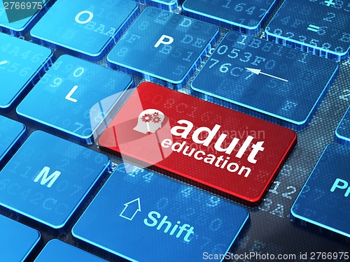 Image of Education concept: Head With Gears and Adult Education on computer keyboard background