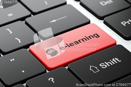 Image of Education concept: Head With Gears and E-learning on computer keyboard background