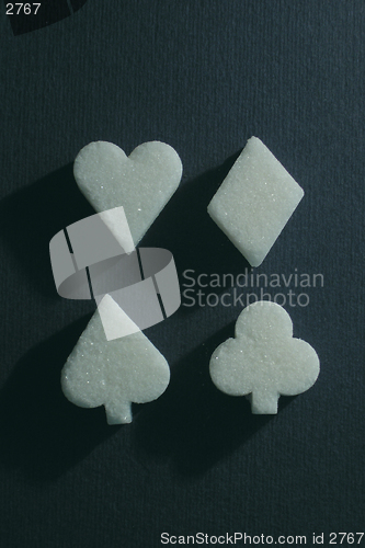 Image of sweet sugar - club, spades, diamond, heart on blue background