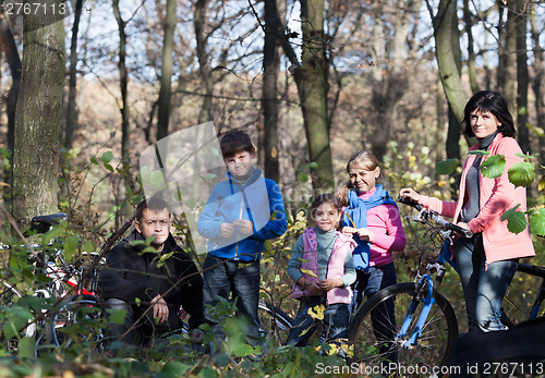 Image of Family portrait with bicycles outdoors