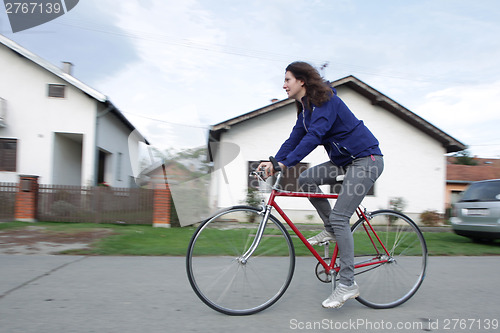 Image of Young woman cycling