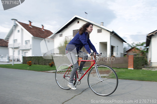 Image of Young woman on bike