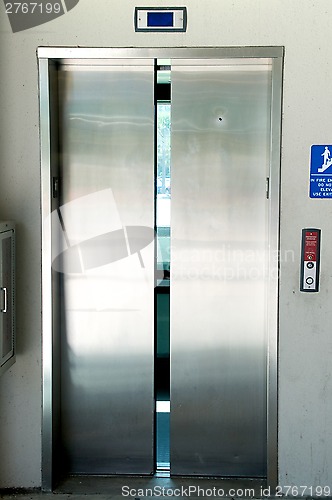 Image of stainless steel elevator doors closing