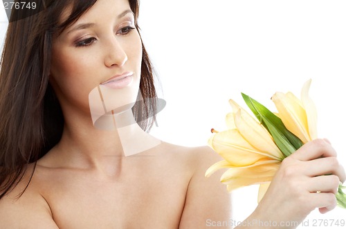 Image of happy brunette with yellow lily flowers #2