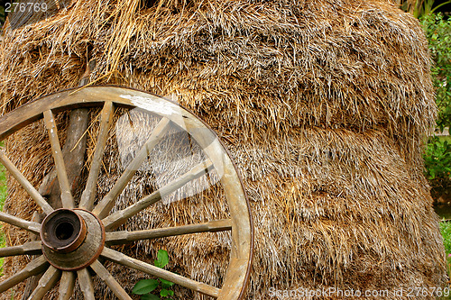 Image of wheel-cart with stack of straw