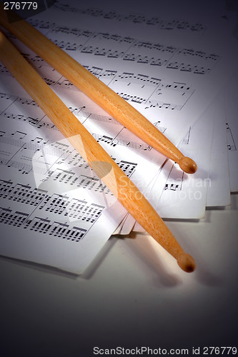 Image of drumstick and music sheet