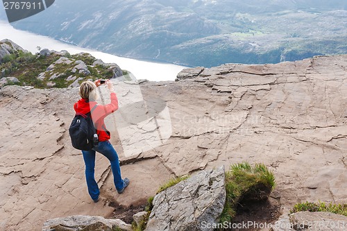 Image of Woman hiker on Pulpit Rock / Preikestolen, Norway