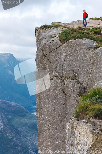 Image of Woman hiker on Pulpit Rock / Preikestolen, Norway