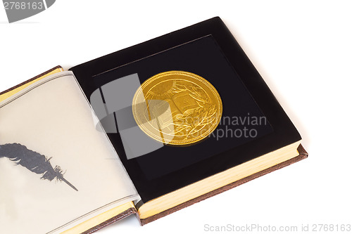 Image of Medal with the image of the book and a laurel branch on a white 