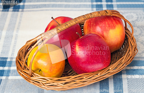 Image of Large apples in a wattled basket.