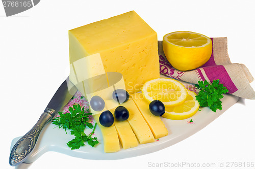 Image of Big piece of cheese, lemon and olives on a white background.