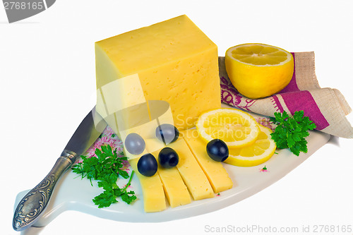 Image of Big piece of cheese, lemon and olives on a white background.