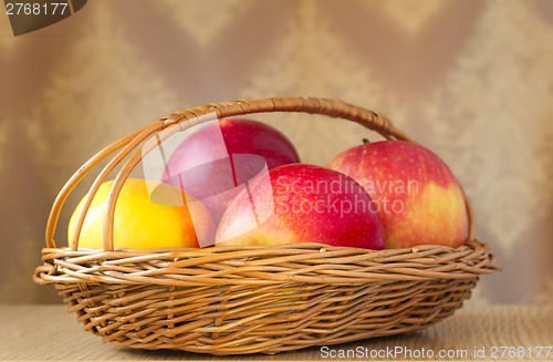 Image of Large apples in a wattled basket.